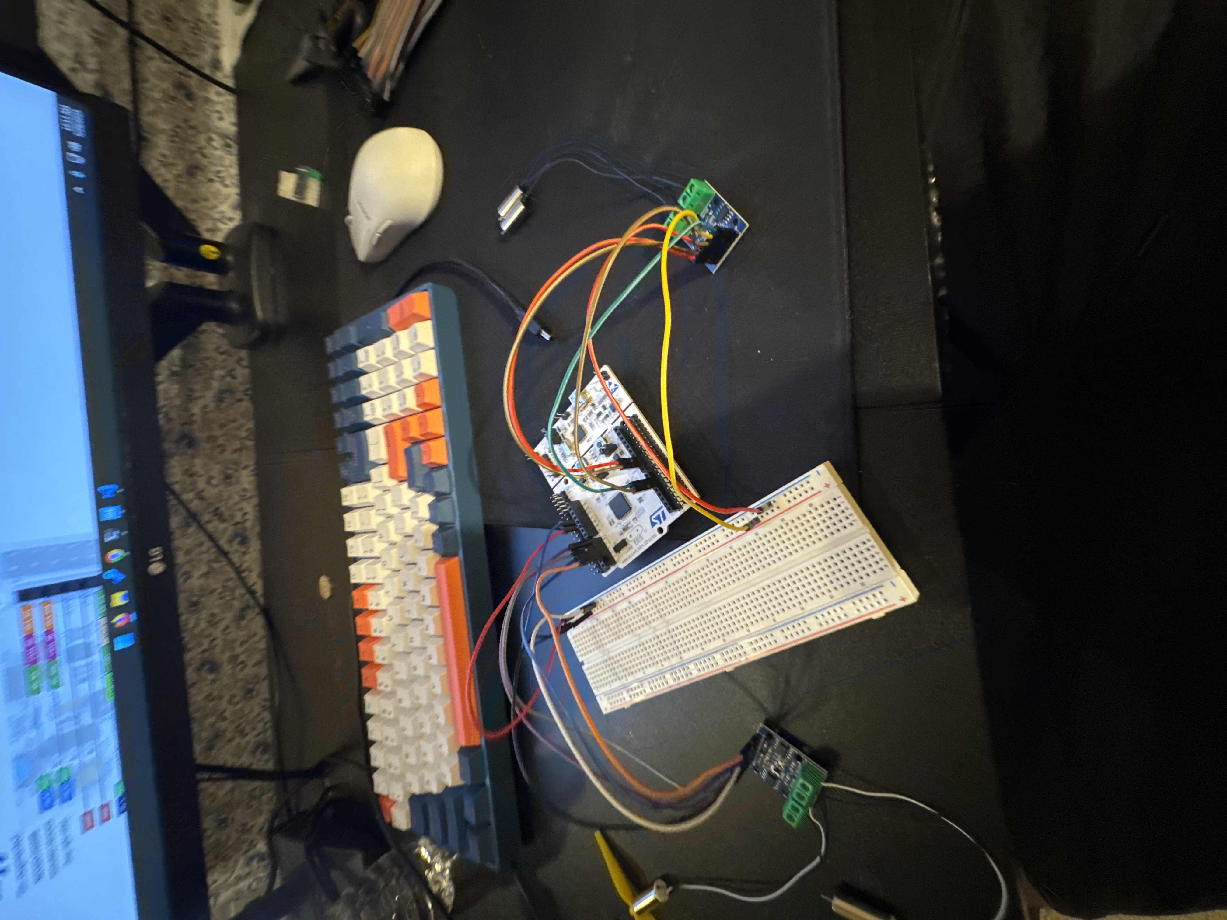 The actual prototype with STM32 board, breadboard, motor drivers, and jumper wiring on the workbench
